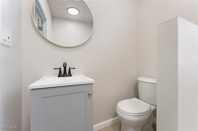 bathroom featuring vanity, toilet, and wood-type flooring