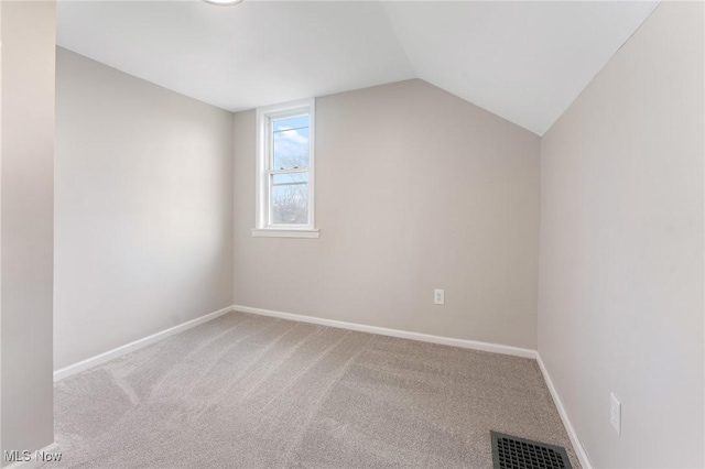 additional living space with lofted ceiling and light carpet