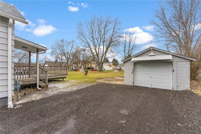 view of yard featuring a garage, an outdoor structure, and a deck