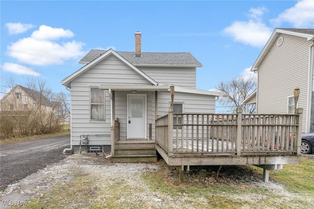 back of house featuring a wooden deck