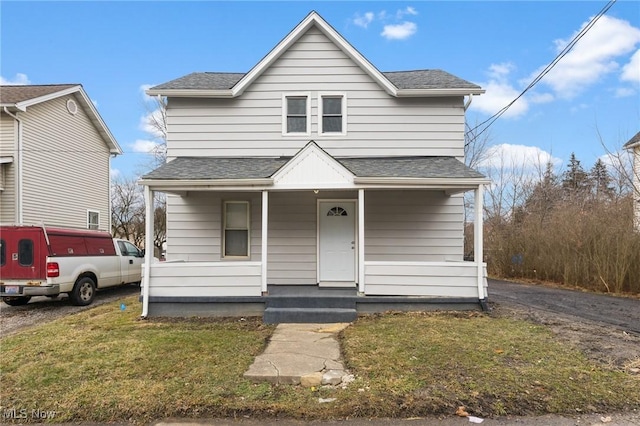 bungalow-style house with a porch and a front lawn