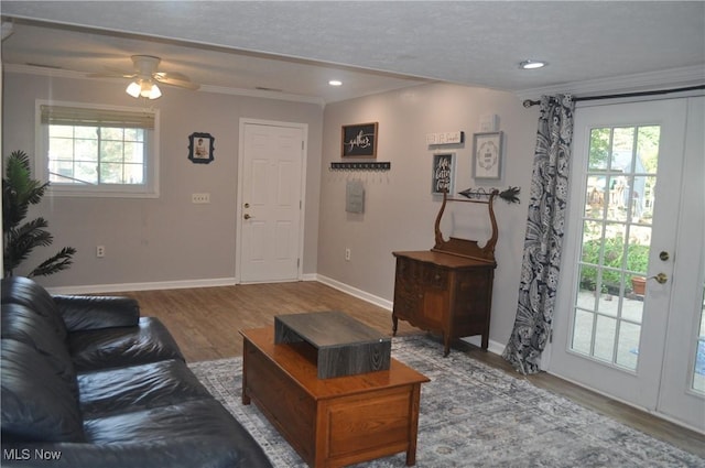 living room featuring crown molding and hardwood / wood-style flooring