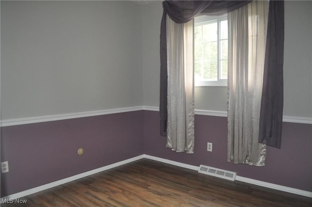 empty room with dark hardwood / wood-style floors