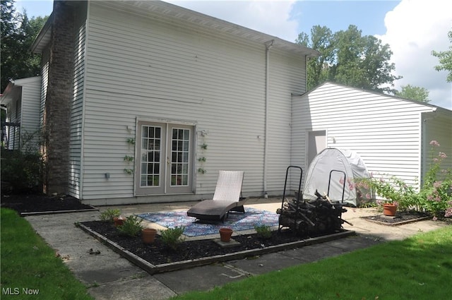 back of property with a patio and french doors