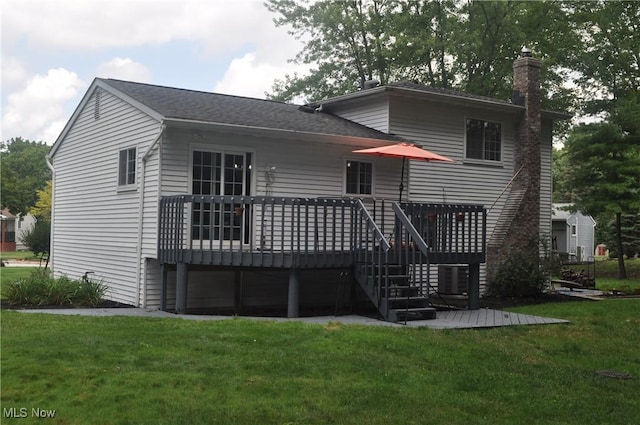 back of house with a yard and a deck