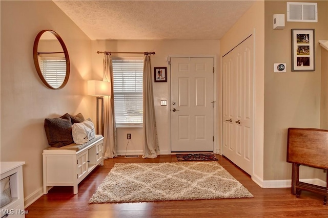 foyer featuring hardwood / wood-style flooring and a textured ceiling