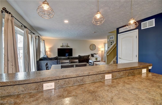 interior space with a textured ceiling