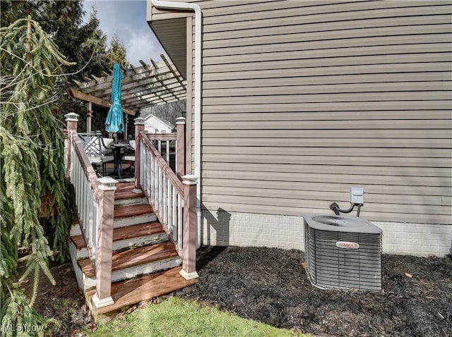 view of home's exterior with a pergola and central air condition unit