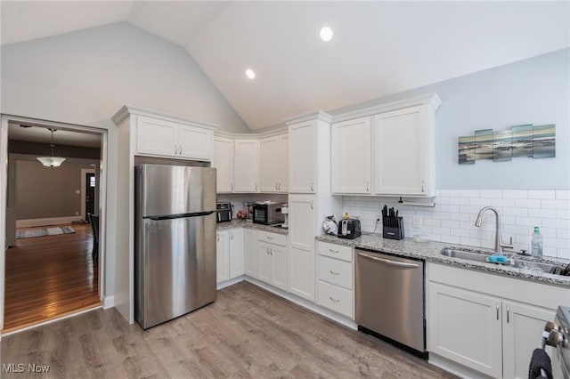 kitchen featuring stainless steel appliances, sink, and white cabinets