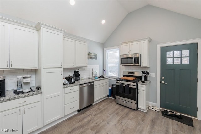 kitchen with white cabinetry, appliances with stainless steel finishes, and sink