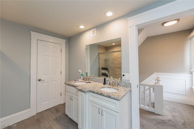 bathroom with vanity, wood-type flooring, and walk in shower