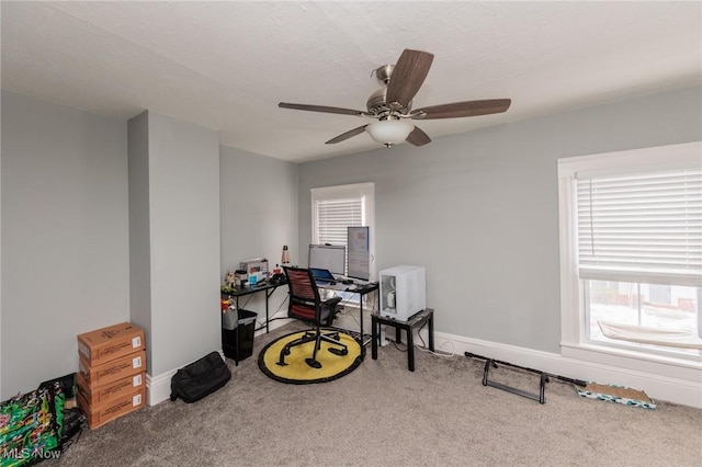 carpeted office space with ceiling fan