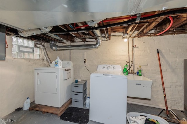 clothes washing area featuring separate washer and dryer and sink