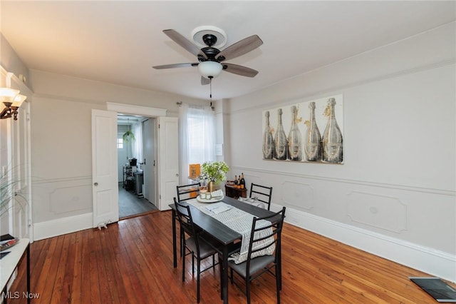 dining space with dark hardwood / wood-style floors and ceiling fan