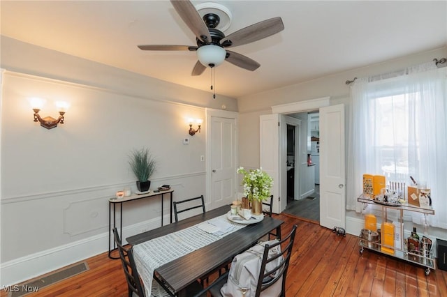 dining room with wood-type flooring and ceiling fan