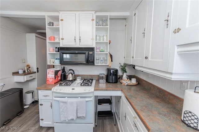 kitchen with white cabinets, light wood-type flooring, and white gas range oven