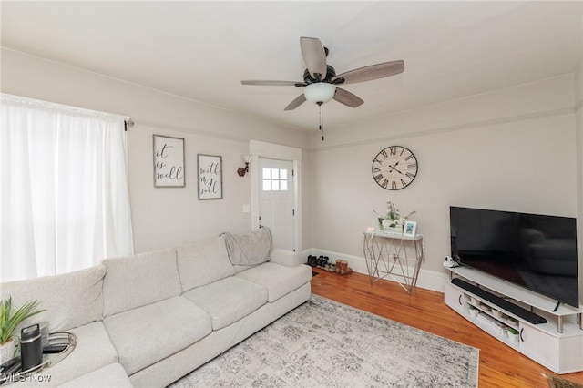 living room featuring wood-type flooring and ceiling fan