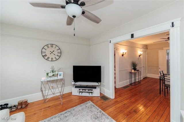 living room featuring hardwood / wood-style flooring and ceiling fan