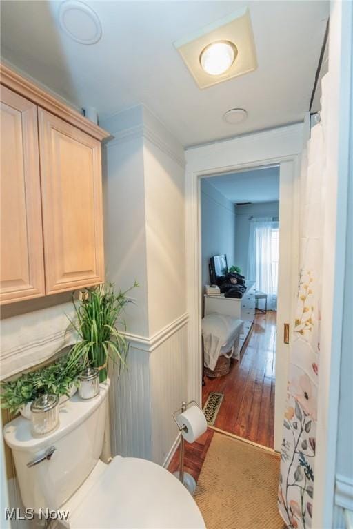 bathroom featuring wood-type flooring and toilet