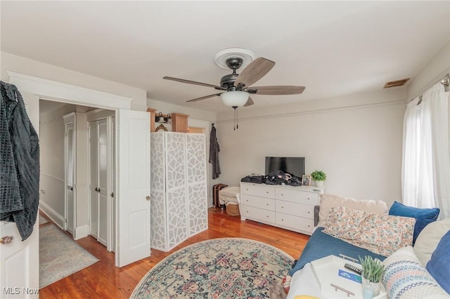 living room featuring hardwood / wood-style flooring and ceiling fan