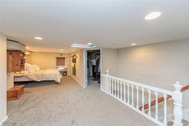 carpeted bedroom featuring a walk in closet