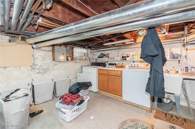 basement featuring washing machine and dryer and electric panel