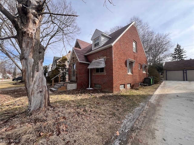 view of side of property featuring an outbuilding and a garage