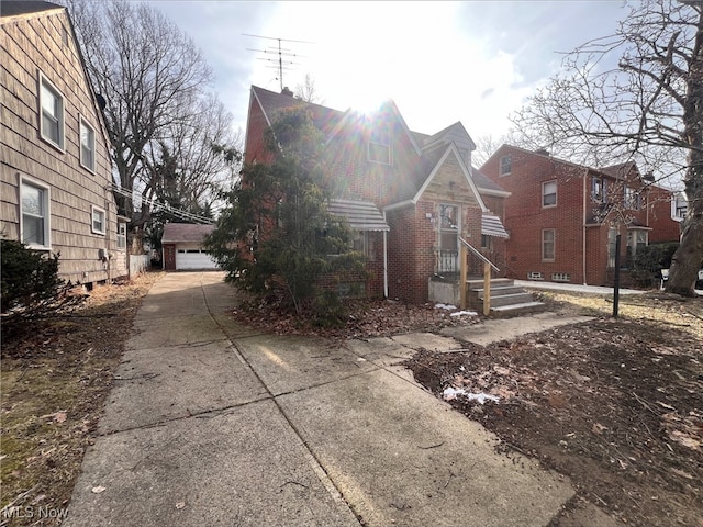 view of front of home with a garage and an outdoor structure