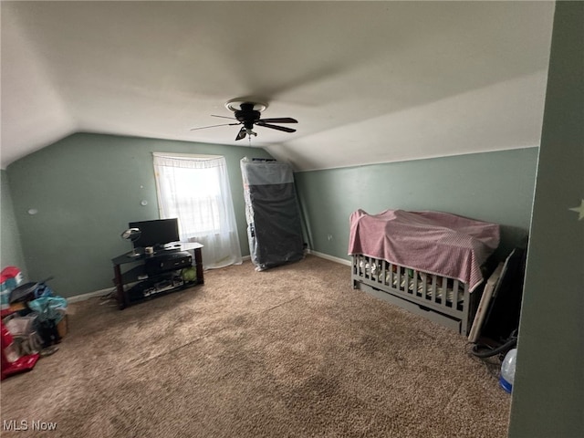 carpeted bedroom with ceiling fan and vaulted ceiling