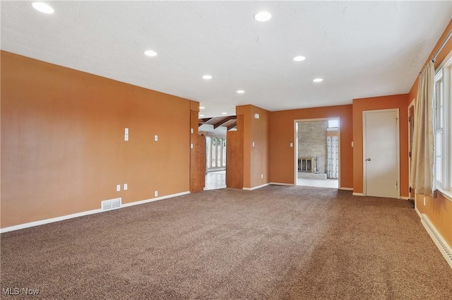 unfurnished living room featuring carpet flooring and a fireplace