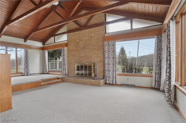 unfurnished living room with high vaulted ceiling, a fireplace, carpet, wooden ceiling, and beam ceiling