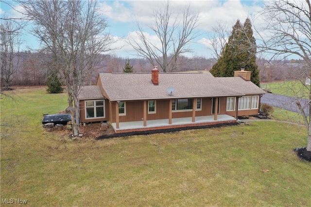 view of front facade featuring a front lawn and a patio area