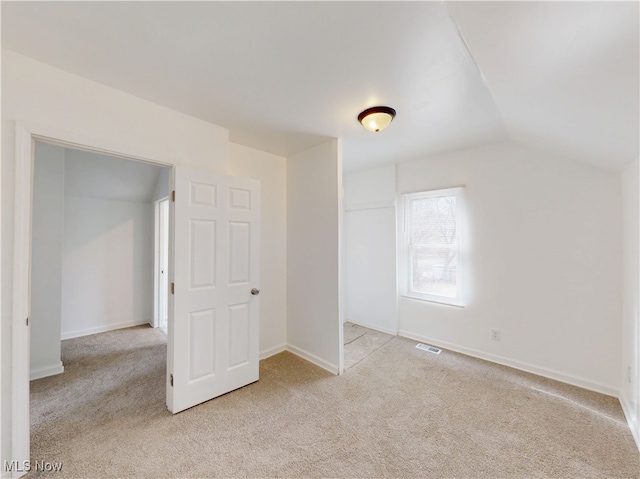 bonus room featuring lofted ceiling and light carpet