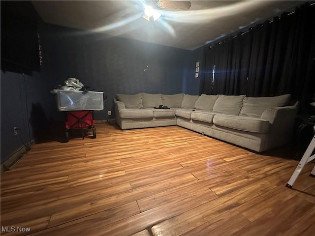 living room with hardwood / wood-style flooring and ceiling fan