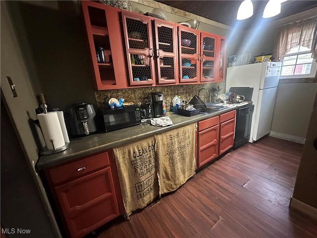 kitchen featuring sink, decorative backsplash, black appliances, and dark hardwood / wood-style floors