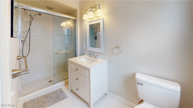 bathroom with a shower with door, vanity, and toilet