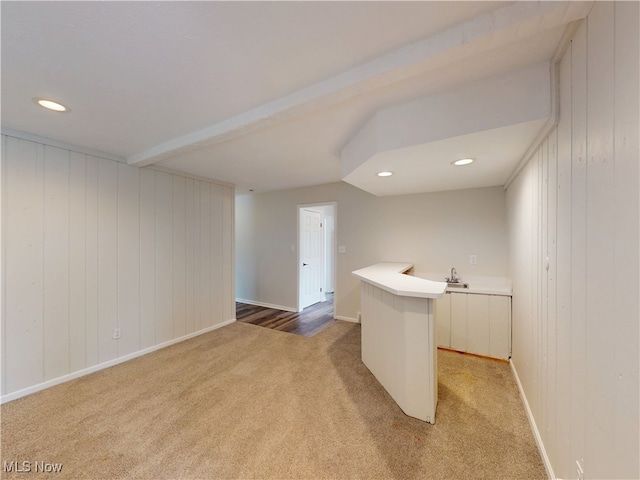 interior space featuring carpet flooring and white cabinets