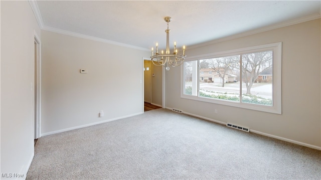 empty room with ornamental molding, carpet flooring, and a chandelier