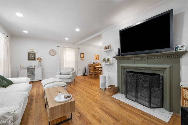 living room featuring crown molding and light wood-type flooring