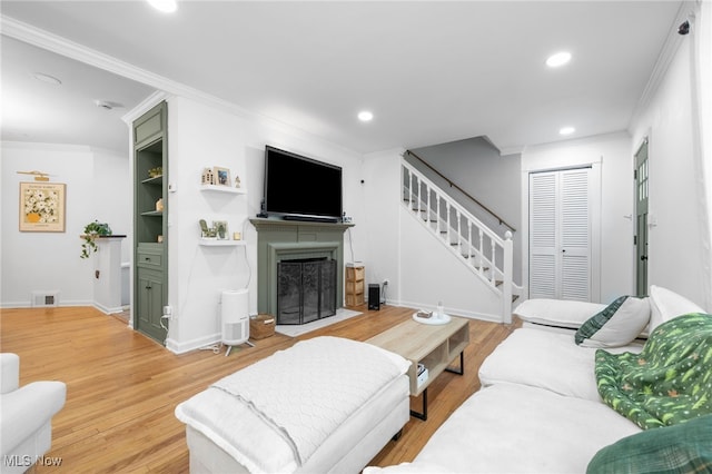 living room featuring hardwood / wood-style flooring and ornamental molding