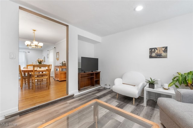 living room with a chandelier and hardwood / wood-style floors