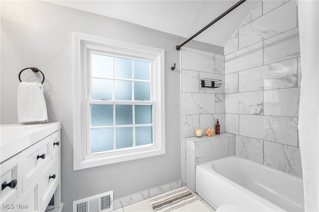 bathroom with shower / tub combo, vanity, and a healthy amount of sunlight