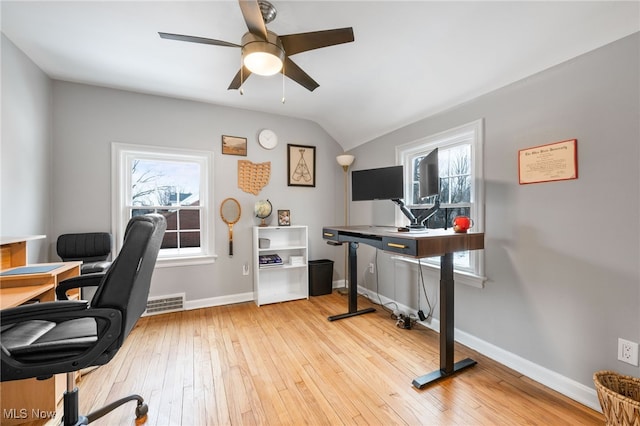 home office with lofted ceiling, a wealth of natural light, light hardwood / wood-style flooring, and ceiling fan