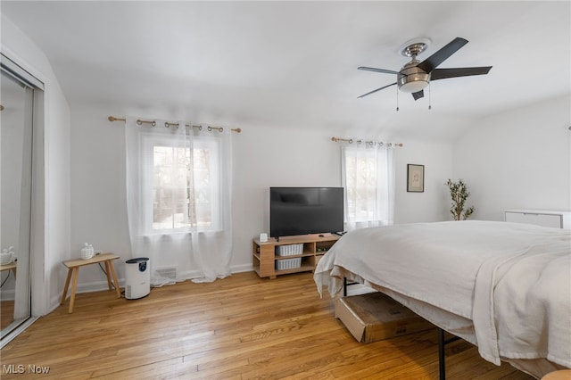 bedroom featuring vaulted ceiling, ceiling fan, and light hardwood / wood-style floors