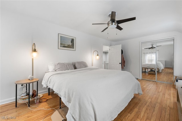 bedroom with ceiling fan, wood-type flooring, and a closet