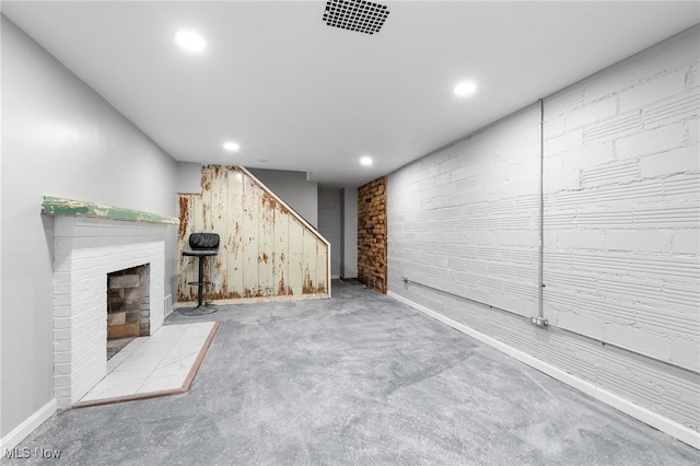 basement featuring a brick fireplace