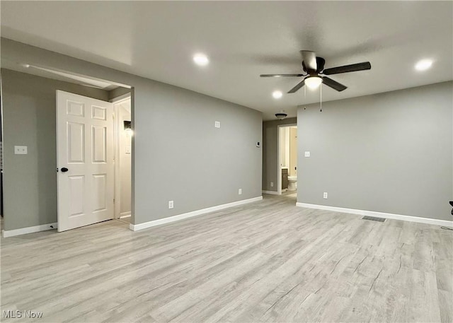 empty room with ceiling fan and light hardwood / wood-style flooring