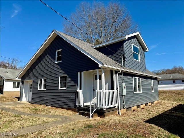 view of front of home with a shingled roof