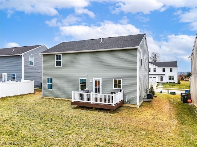 back of house with a wooden deck, a lawn, and central air condition unit