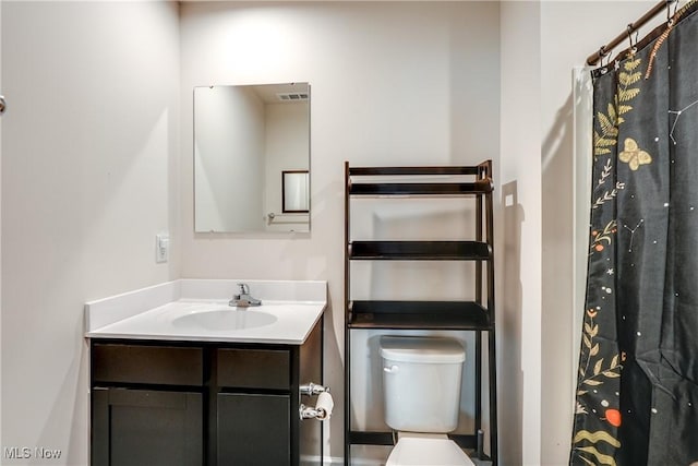 bathroom featuring vanity and toilet